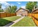 Lush backyard featuring green grass, wooden fencing, and inviting outdoor space at 900 Jackson St, Denver, CO 80206