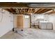 Unfinished basement space with exposed ceiling, laundry area, and room for storage at 900 Jackson St, Denver, CO 80206