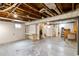 Unfinished basement with painted walls, exposed ceiling, and two windows at 900 Jackson St, Denver, CO 80206