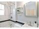 Modern bathroom with white subway tile, black accents, and chrome fixtures; shower and vanity featured at 900 Jackson St, Denver, CO 80206