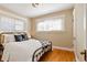 The bedroom has warm-toned walls, hardwood floors, and lots of natural light at 900 Jackson St, Denver, CO 80206
