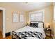 The sun-filled bedroom has warm-toned walls, hardwood floors, and lots of natural light at 900 Jackson St, Denver, CO 80206