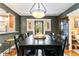 The dining room boasts hardwood floors, decorative lighting, and an open view into the kitchen at 900 Jackson St, Denver, CO 80206