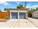 Exterior of detached two car garage with gray doors, brick exterior, and concrete drive at 900 Jackson St, Denver, CO 80206