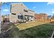 A spacious backyard with a well-maintained lawn and a cozy patio seating area at 180 S Carlton St, Castle Rock, CO 80104