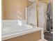 Inviting bathroom featuring a soaking tub with glass shower doors at 180 S Carlton St, Castle Rock, CO 80104