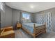 Comfortable bedroom with a wooden bed frame and carpet flooring, creating a cozy retreat at 180 S Carlton St, Castle Rock, CO 80104