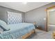 This cozy bedroom features gray walls and carpet, with a light blue comforter at 180 S Carlton St, Castle Rock, CO 80104