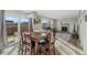 Cozy dining area with a wooden table, fireplace, and ample natural light at 180 S Carlton St, Castle Rock, CO 80104