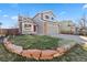 Charming two-story home with a well-manicured lawn and mature landscaping at 180 S Carlton St, Castle Rock, CO 80104