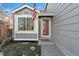 Charming home exterior featuring gray siding, a red door, and American flag waving at 180 S Carlton St, Castle Rock, CO 80104