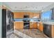 Modern kitchen with stainless steel appliances, wood cabinets and an eye-catching backsplash at 180 S Carlton St, Castle Rock, CO 80104