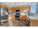 Well-equipped kitchen with stainless steel appliances, ample counter space, and wood cabinets at 180 S Carlton St, Castle Rock, CO 80104