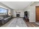 Cozy living room with a decorative fireplace, comfortable couch and a large window at 180 S Carlton St, Castle Rock, CO 80104