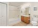 A clean bathroom featuring a shower-tub combination, toilet, and vanity with sink and mirror at 5537 Lewis Ct # 1, Arvada, CO 80002