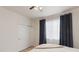 Bedroom featuring a ceiling fan, closet, light walls, and blue curtains over a sunlit window at 5537 Lewis Ct # 1, Arvada, CO 80002