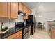 Bright kitchen features stainless steel appliances and a granite countertop with light wood cabinets at 5537 Lewis Ct # 1, Arvada, CO 80002