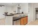 A view of the kitchen sink, faucet, wood cabinets and granite countertops, adjacent to laundry area at 5537 Lewis Ct # 1, Arvada, CO 80002