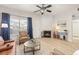 Cozy living room with light wood floors, a fireplace and a large window at 5537 Lewis Ct # 1, Arvada, CO 80002
