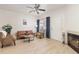 Bright living room with light wood floors, neutral furniture, and a white door at 5537 Lewis Ct # 1, Arvada, CO 80002