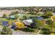 Aerial view of community pool, clubhouse, tennis courts, parking, and pond at 3076 W 112Th Ct # C, Westminster, CO 80031