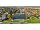 Stunning aerial view of a neighborhood with tree-lined streets, scenic ponds, and well-maintained landscaping at 3076 W 112Th Ct # C, Westminster, CO 80031