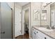 Well-lit bathroom featuring a walk-in shower, white cabinets, a granite countertop, and modern fixtures at 3076 W 112Th Ct # C, Westminster, CO 80031