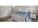 Comfortable bedroom with a beautifully crafted white-wash wood bed frame, plush bedding, and an ensuite bathroom at 3076 W 112Th Ct # C, Westminster, CO 80031