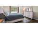 Bright bedroom featuring a large window, white-wash wood furniture, a decorative mirror, and neutral-toned decor at 3076 W 112Th Ct # C, Westminster, CO 80031
