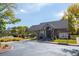 Stone clubhouse features a gray shingle roof, red door, and adjacent parking lot at 3076 W 112Th Ct # C, Westminster, CO 80031