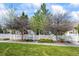 Inviting home featuring a white picket fence, mature trees, and a well-maintained lawn at 3076 W 112Th Ct # C, Westminster, CO 80031