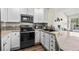 Close-up of the kitchen featuring updated appliances and counters at 3076 W 112Th Ct # C, Westminster, CO 80031