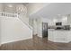 Open-concept kitchen and living room area with hardwood floors and modern lighting at 3076 W 112Th Ct # C, Westminster, CO 80031