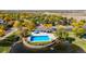 Bright blue outdoor swimming pool and deck overlook a pond and lush green landscape at 3076 W 112Th Ct # C, Westminster, CO 80031