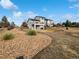 Home exterior with a backyard featuring gravel landscaping, stone pathways, and a private outdoor area at 6400 N Windfield Ave, Parker, CO 80134
