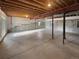 Large unfinished basement with concrete floor and exposed wood ceiling beams offers potential for customization at 6400 N Windfield Ave, Parker, CO 80134