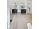 Modern bathroom featuring and sinks, a glass-door shower, and neutral tile at 6400 N Windfield Ave, Parker, CO 80134