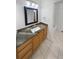 Bathroom vanity with framed mirror, granite counter, and tiled floor at 6400 N Windfield Ave, Parker, CO 80134