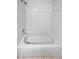 Clean white bathtub with tiled surround and chrome shower fixtures at 6400 N Windfield Ave, Parker, CO 80134