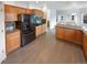 Modern kitchen with wooden cabinets, granite countertops, stainless steel appliances, and hardwood flooring at 6400 N Windfield Ave, Parker, CO 80134