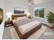 Inviting main bedroom with a king-size bed and a scenic view from a large bright window at 6400 N Windfield Ave, Parker, CO 80134