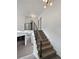 Modern staircase featuring metal railings and wood treads ascending from the lower level at 6400 N Windfield Ave, Parker, CO 80134