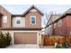 Two-story townhome with attached garage and neutral color palette at 9310 E 61St Ave, Denver, CO 80238