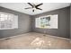 Bright bedroom with neutral carpet, gray walls, and bright white window shutters at 3350 S Forest St, Denver, CO 80222