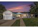 Charming home featuring a well-manicured front yard and a single-car garage with an orange front door at sunset at 3350 S Forest St, Denver, CO 80222
