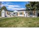 Charming home featuring a well-manicured front yard and a single-car garage with an orange front door at 3350 S Forest St, Denver, CO 80222