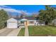 Charming home featuring a well-manicured front yard and a single-car garage with an orange front door at 3350 S Forest St, Denver, CO 80222