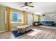 Bright living area featuring a ceiling fan and large windows with natural light at 3350 S Forest St, Denver, CO 80222