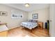 Bright bedroom featuring hardwood floors, a window, and neutral paint at 6261 S Adams Dr, Centennial, CO 80121