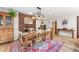 Warm dining area with hardwood floors, a brick accent wall, and elegant lighting at 6261 S Adams Dr, Centennial, CO 80121